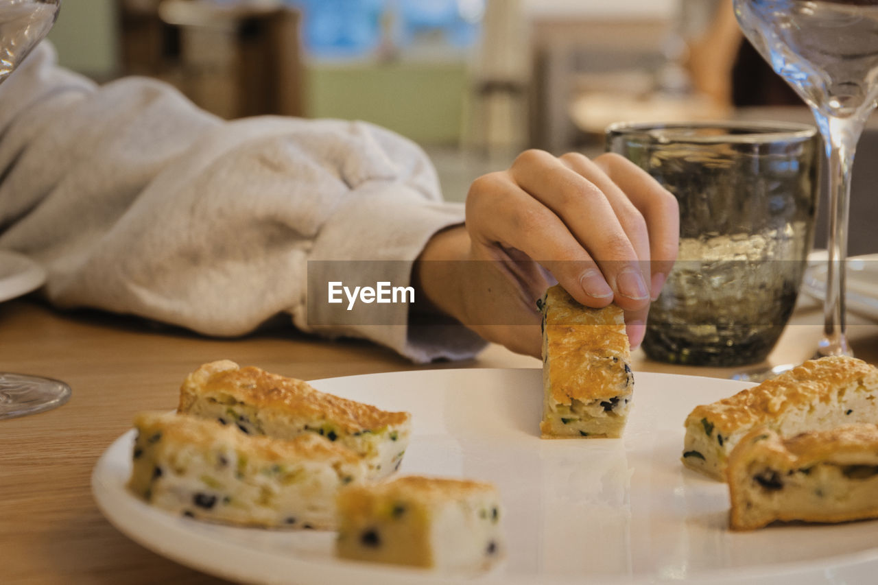 Cropped hand of person having food