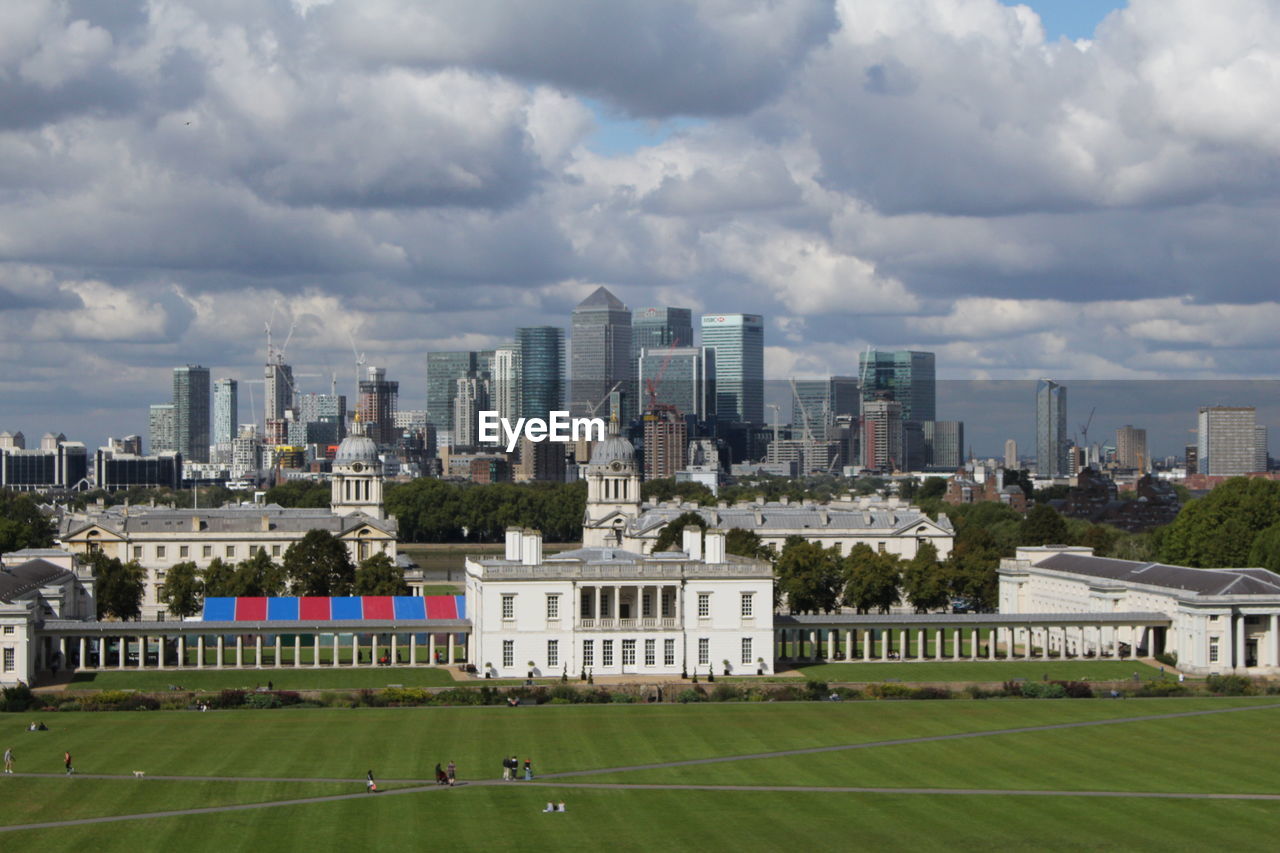 View of cityscape against cloudy sky