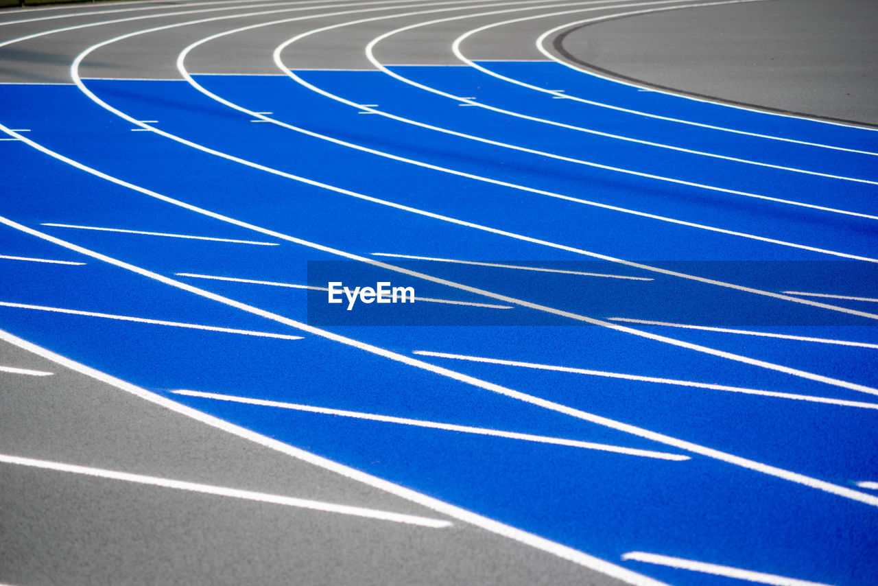 Full frame shot of blue sports track with crisp lines