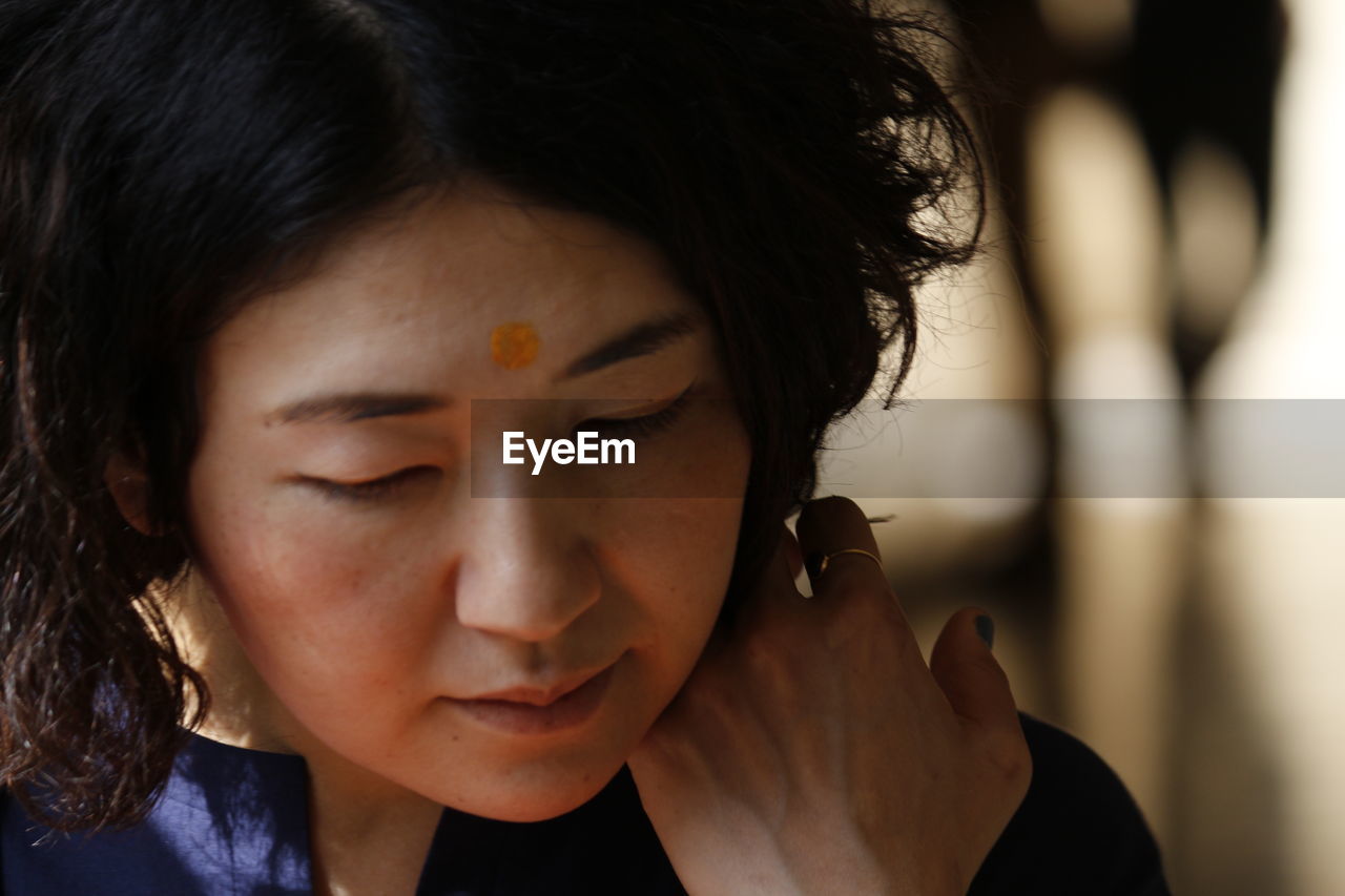 Close-up of mature woman with tikka on her forehead