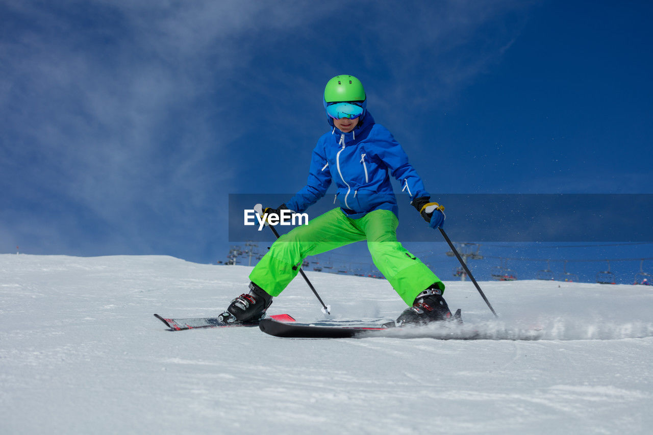 full length of man skiing on snow covered field