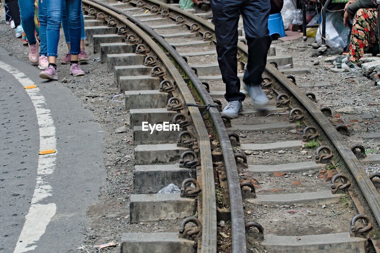 high angle view of people walking on railroad station