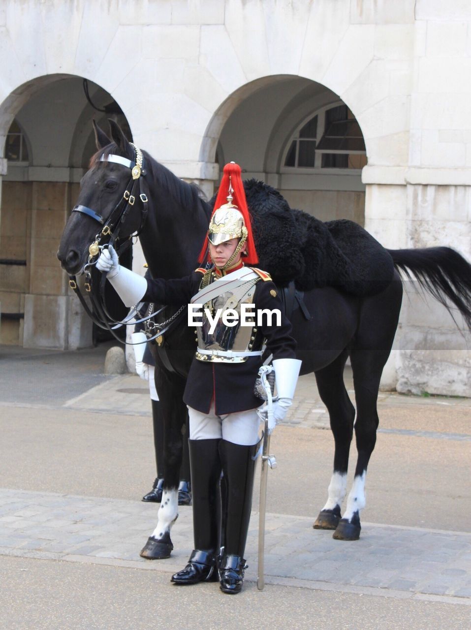 Honor guard standing by horse against building