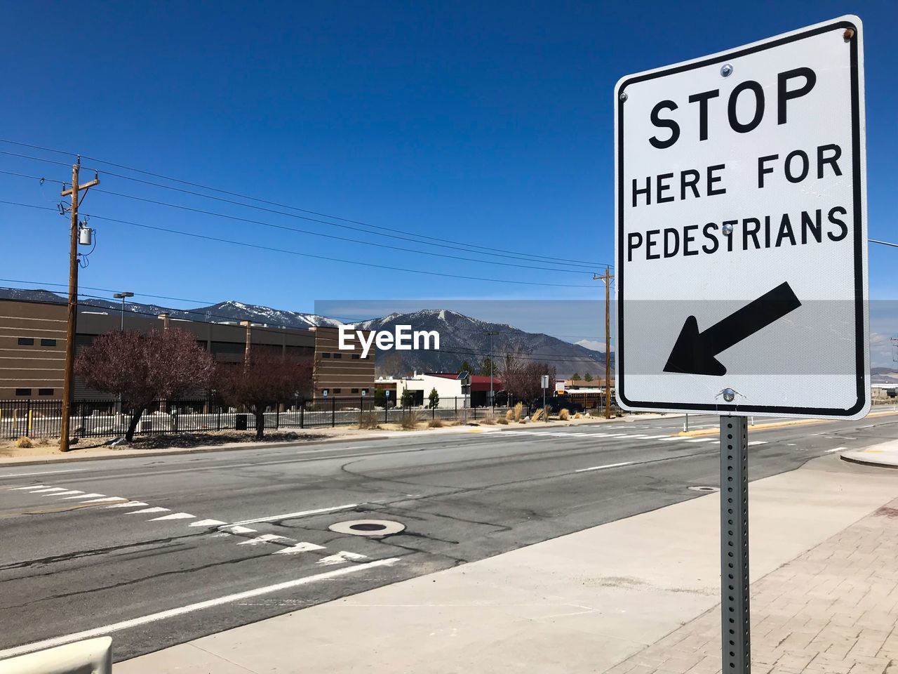 ROAD SIGNS AGAINST BLUE SKY