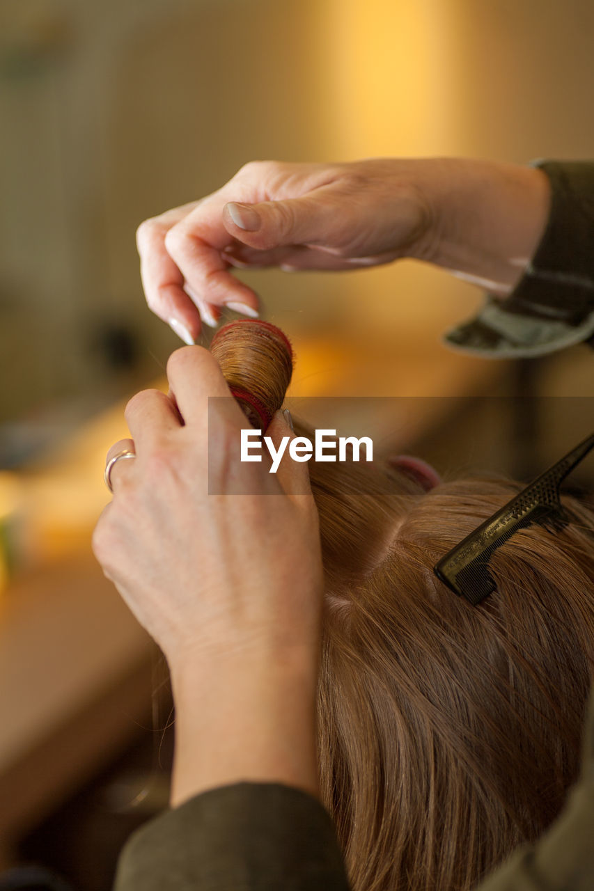 Close-up of woman holding hair home