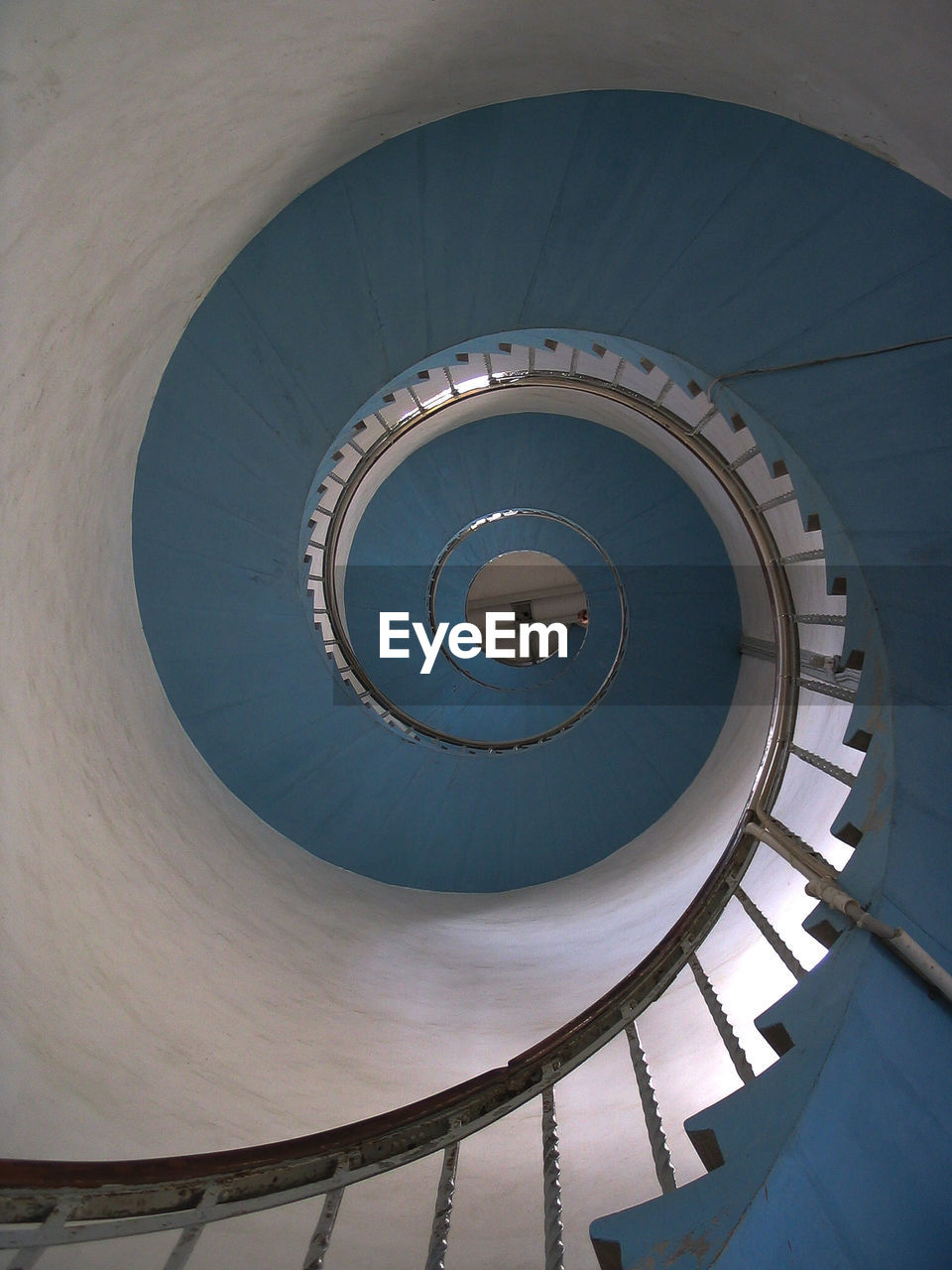 DIRECTLY BELOW SHOT OF SPIRAL STAIRCASE ON BUILDING