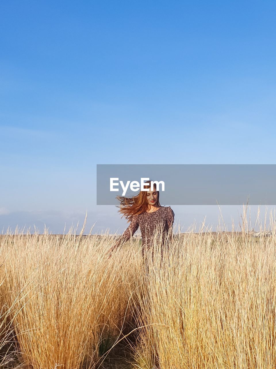 Full length of woman on grass in field against sky