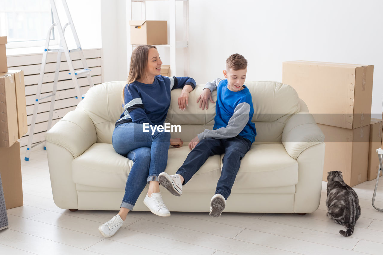 YOUNG COUPLE SITTING ON SOFA