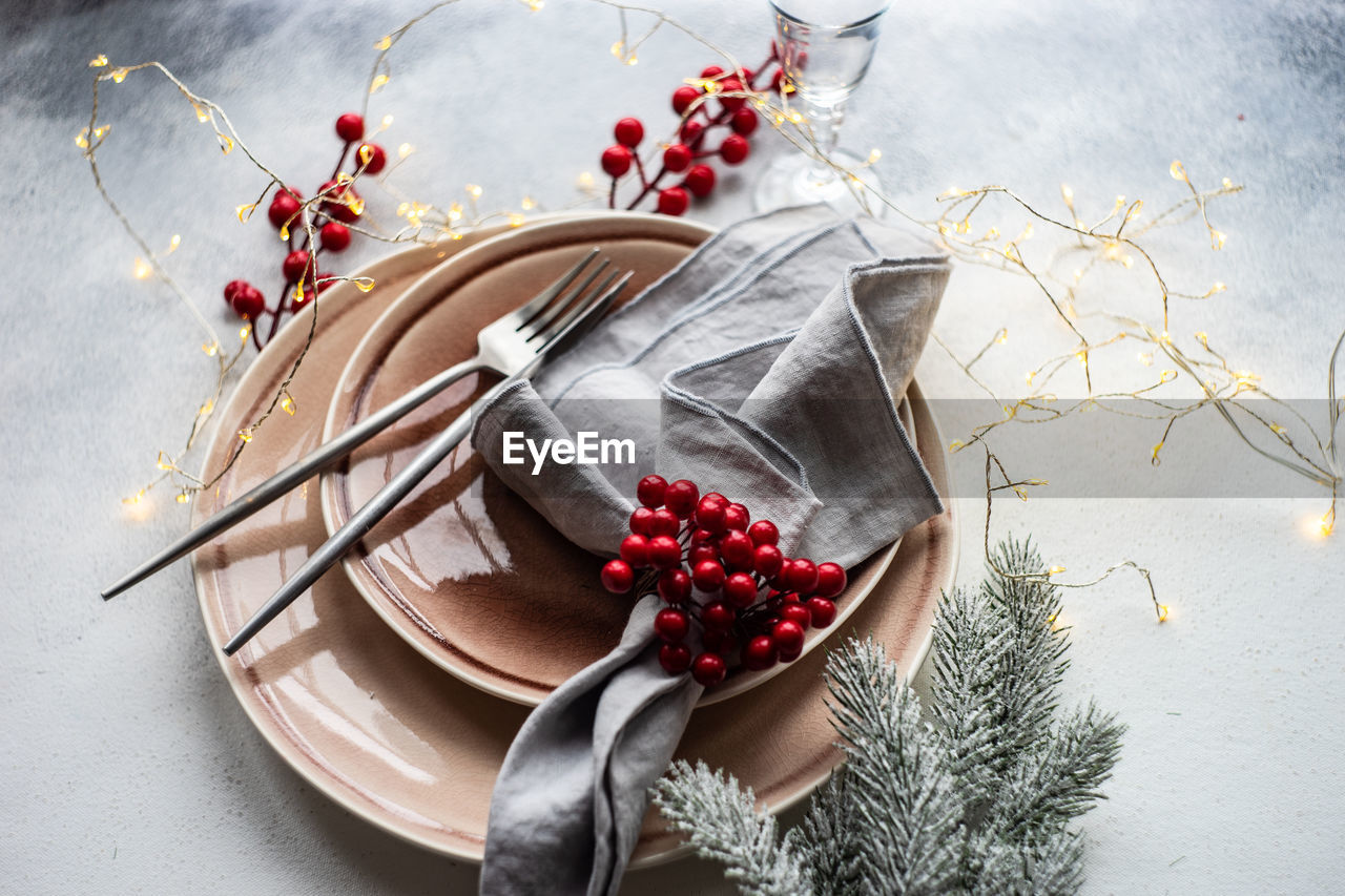 Festive place setting for celebration the christmas eve on concrete table