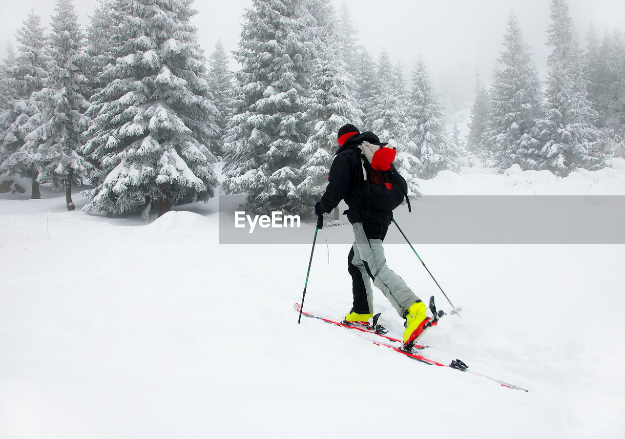 Man skiing on snow covered field