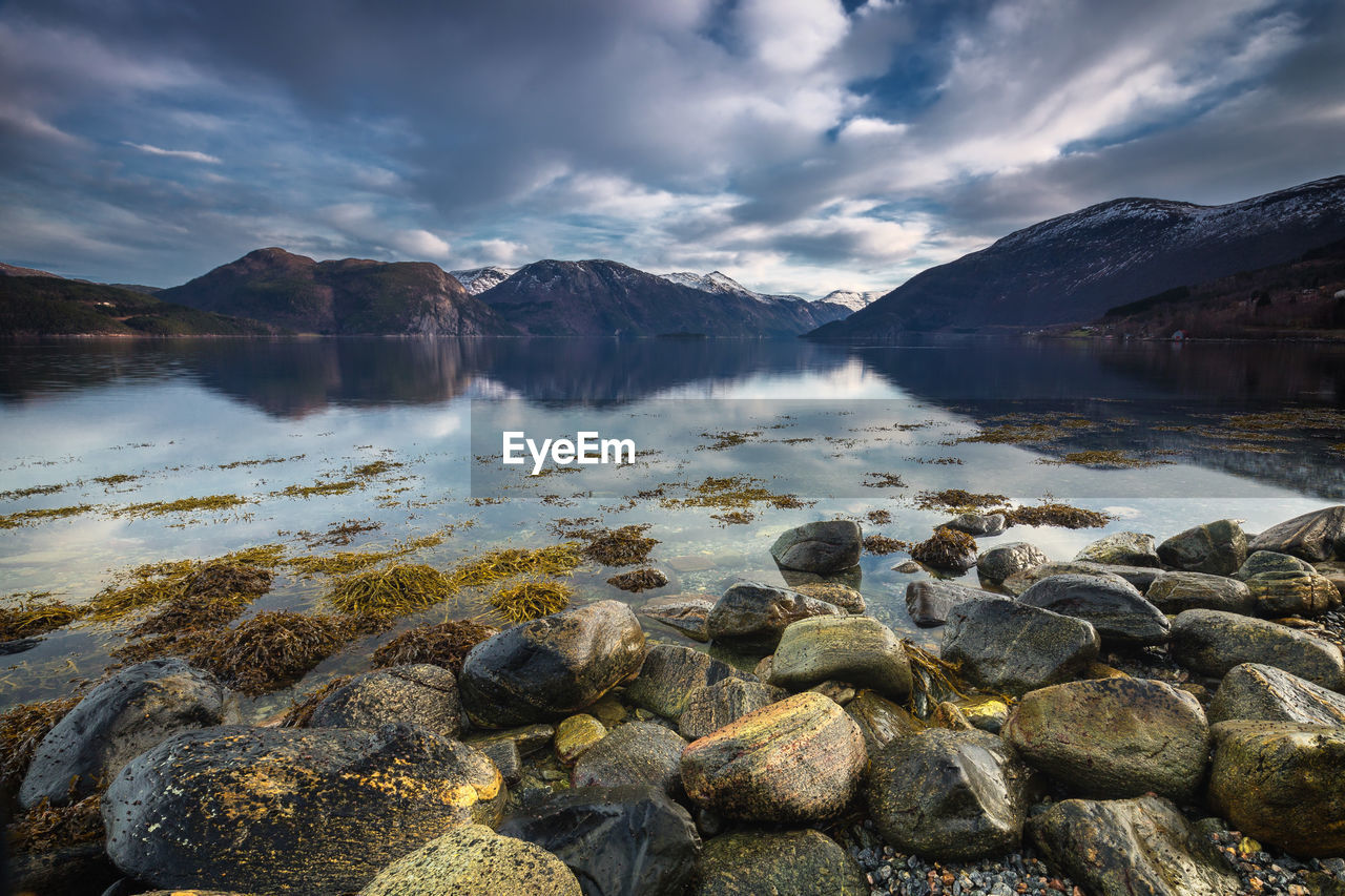 Scenic view of lake and mountains against sky