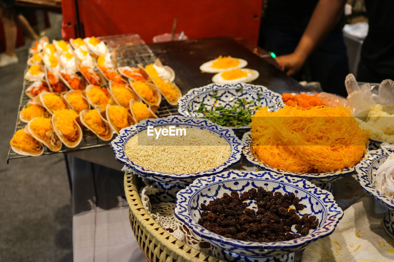 A table with typical colourful thai dishes.