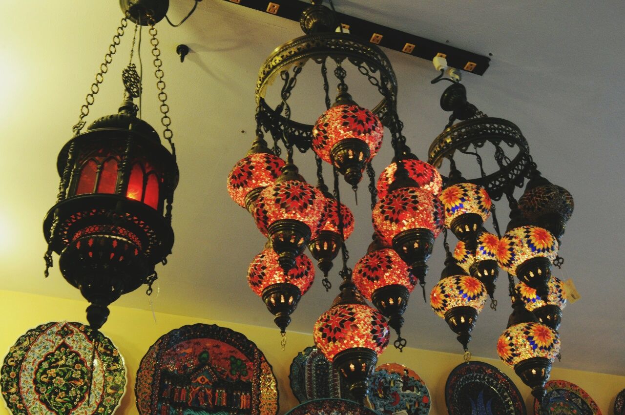 Low angle view of antique lights hanging from ceiling