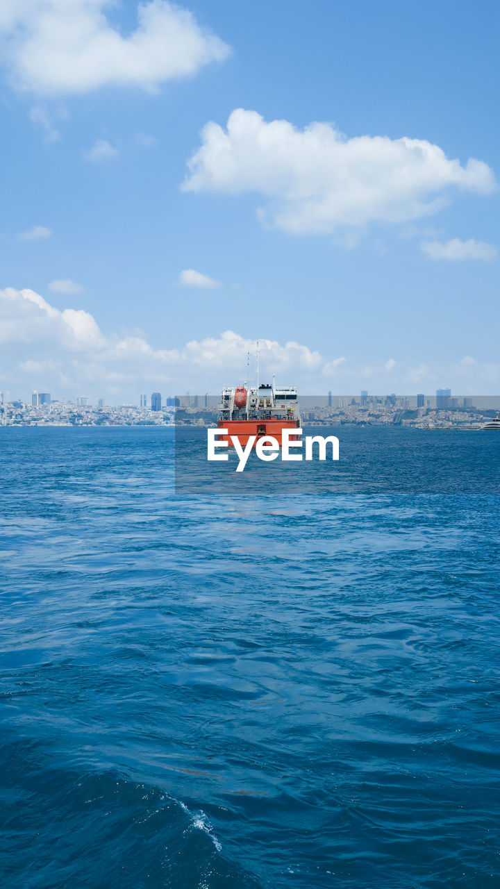 NAUTICAL VESSEL SAILING ON SEA AGAINST SKY