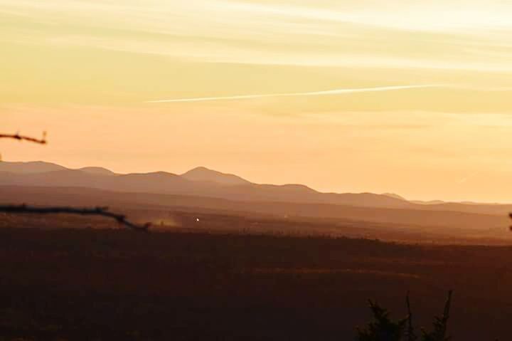 SCENIC VIEW OF MOUNTAINS AT SUNSET