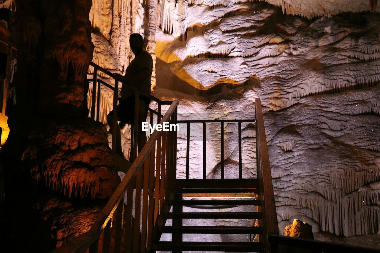 LOW ANGLE VIEW OF STAIRCASE IN CAVE