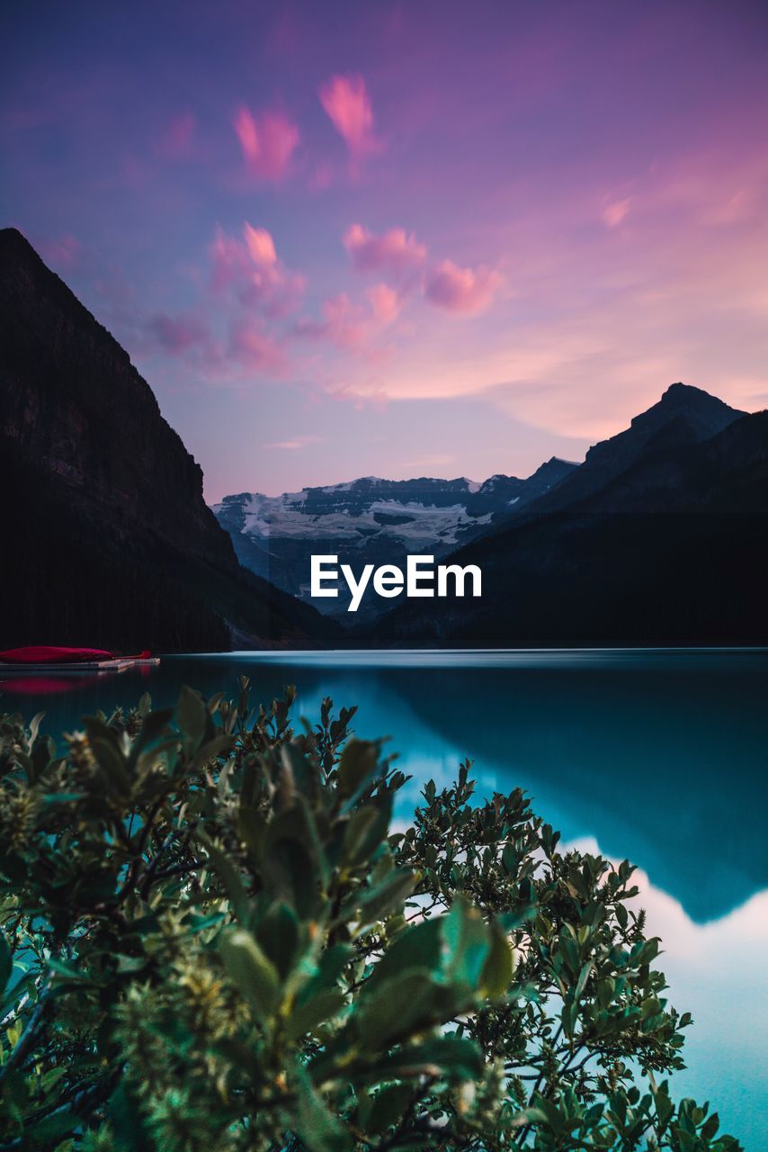 Scenic view of lake and mountains against sky