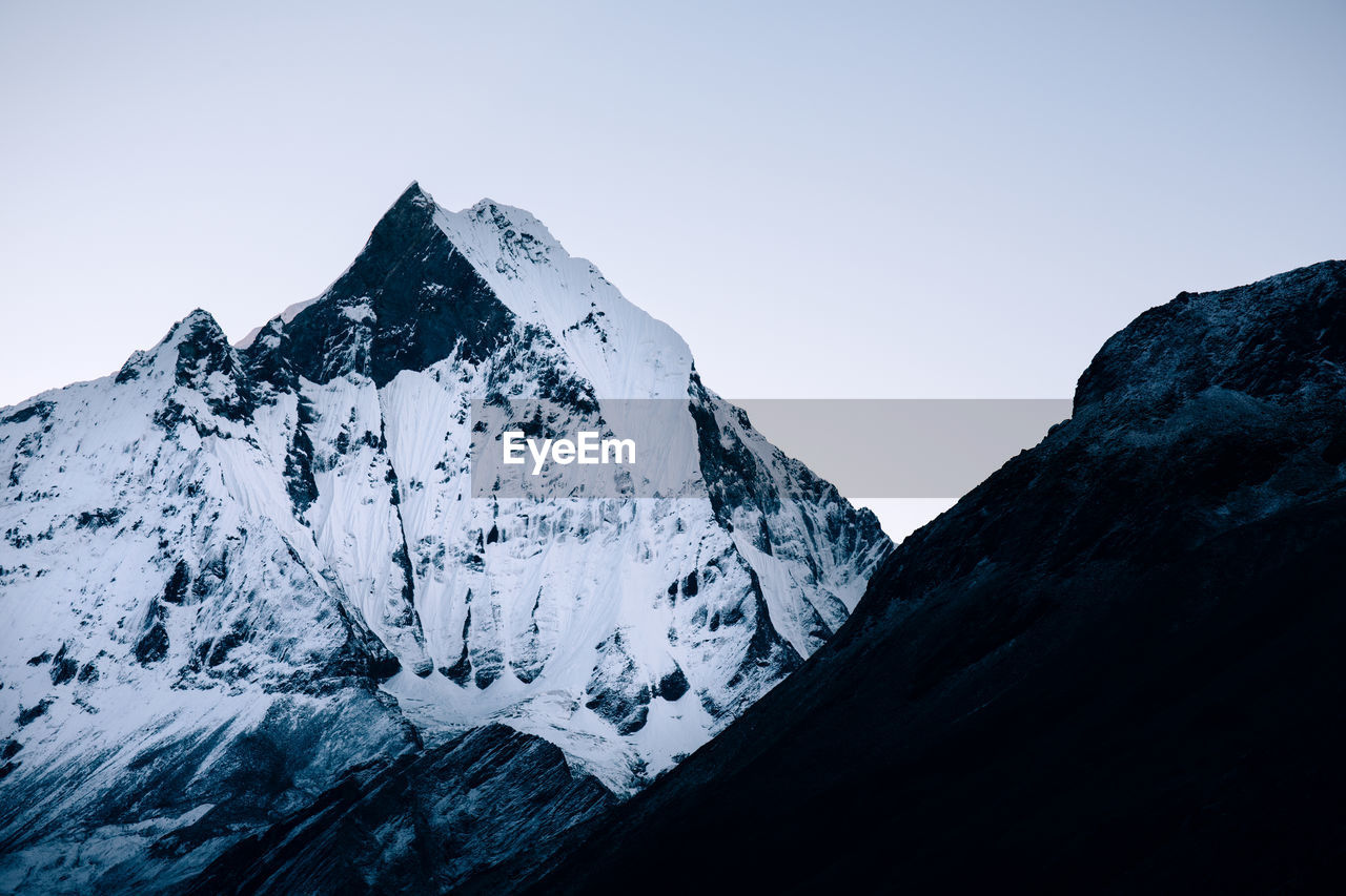 Scenic view of snowcapped mountains against clear sky