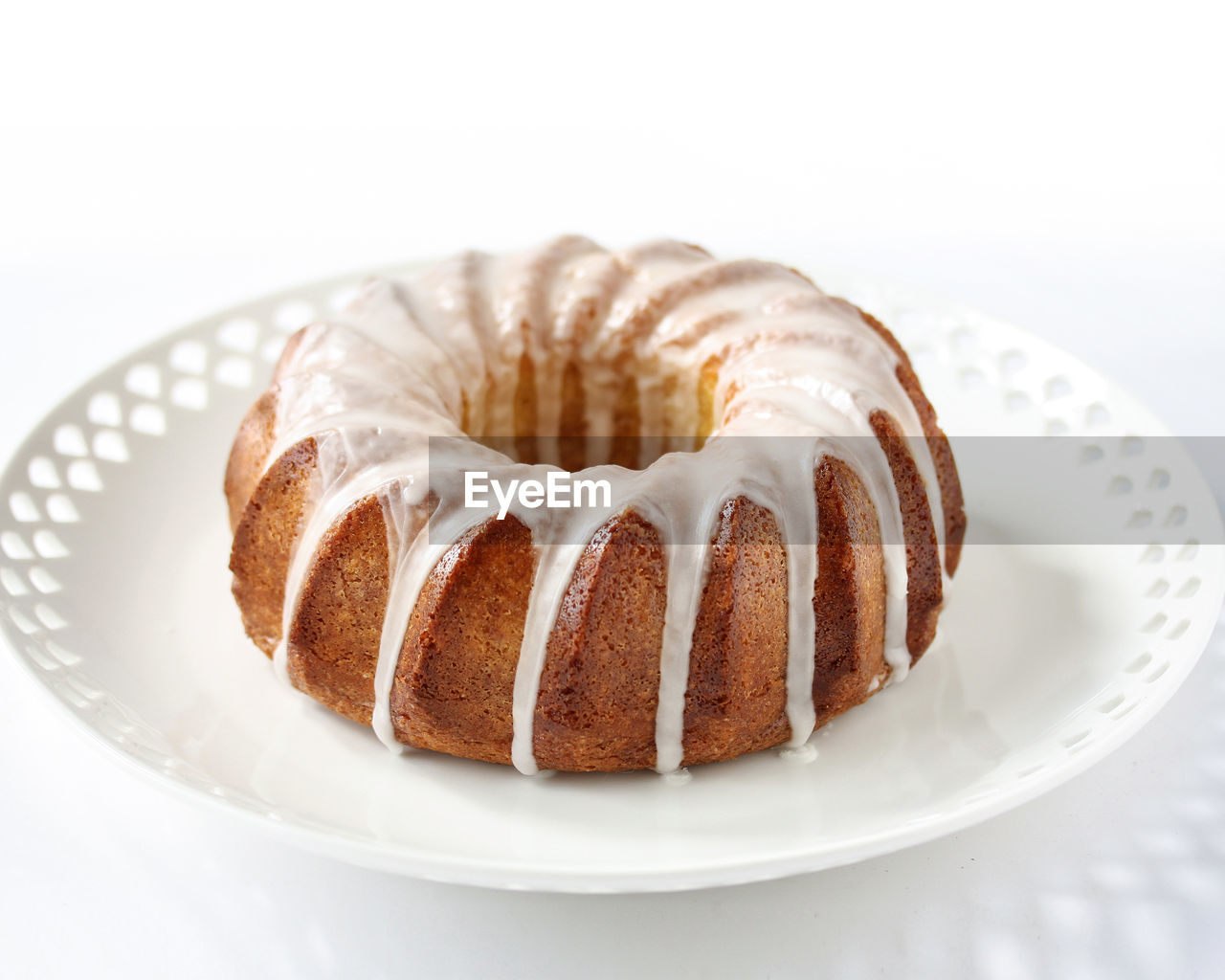 Close-up of sugar glazed donut on plate