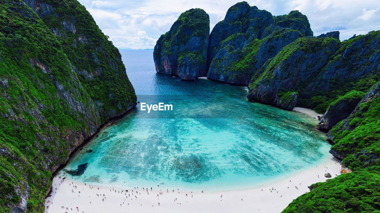 water, scenics - nature, land, beauty in nature, nature, environment, sea, landscape, travel destinations, travel, body of water, beach, sky, mountain, rock, tourism, turquoise colored, lagoon, cloud, holiday, no people, trip, vacation, outdoors, tranquility, coastline, plant, blue, cliff, coast, tropical climate, idyllic, tranquil scene, non-urban scene, island, social issues, panoramic, rock formation, bay of water, day, bay, summer, geology, tree, terrain