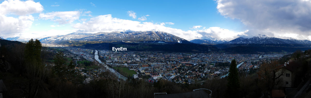 PANORAMIC SHOT OF TOWNSCAPE BY MOUNTAINS