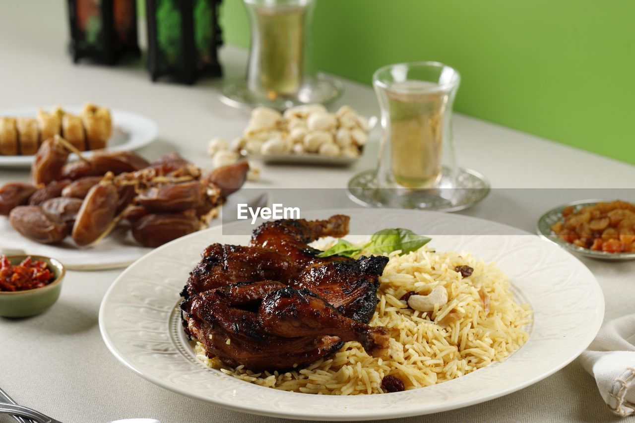 Kabsa, arabian dish made of long grain basmati rice, roasted whole chicken, onion, spices 