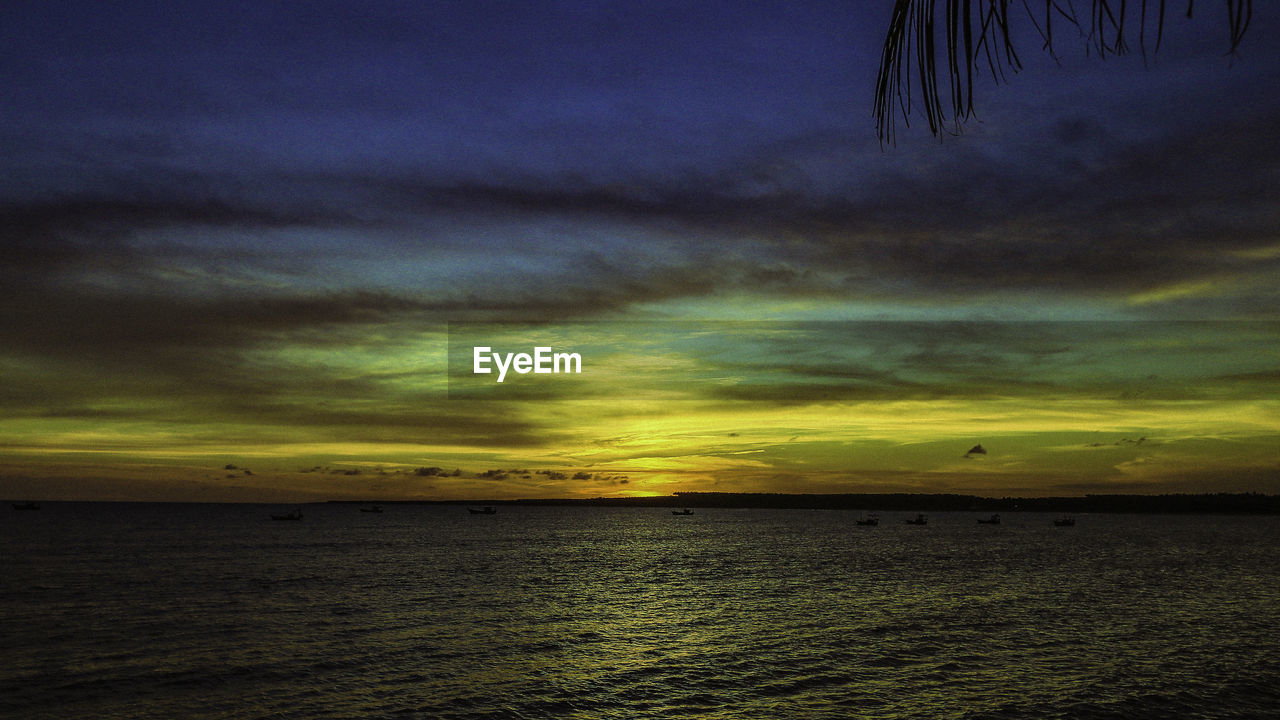 Scenic view of sea against dramatic sky