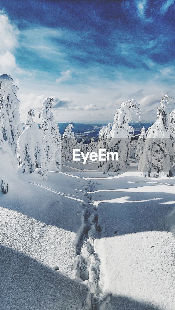 Snow covered landscape against sky