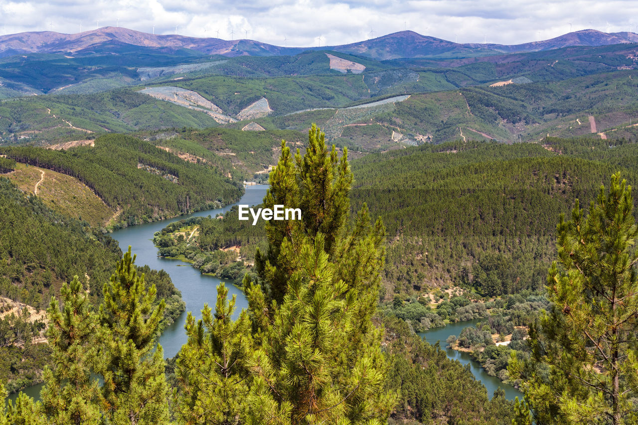 High angle view of lake amidst landscape against mountains