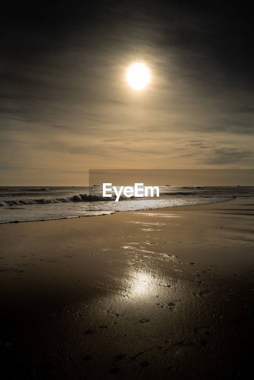water, sky, sea, beach, land, beauty in nature, scenics - nature, tranquility, horizon over water, light, sun, sunlight, nature, tranquil scene, horizon, reflection, cloud, sunset, moon, wave, astronomical object, sand, dawn, no people, ocean, idyllic, darkness, outdoors, wind wave, moonlight, body of water, evening, motion, non-urban scene, coast