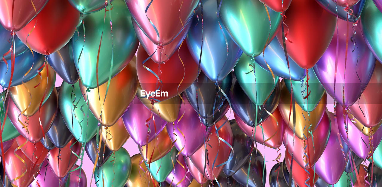 LOW ANGLE VIEW OF MULTI COLORED BALLOONS HANGING ON CEILING