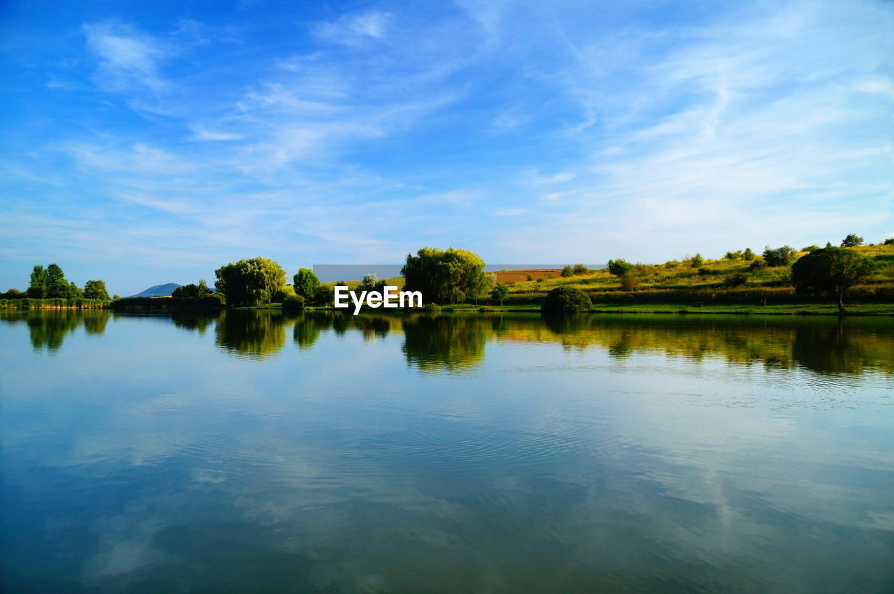 Scenic view of reflection of trees against sky