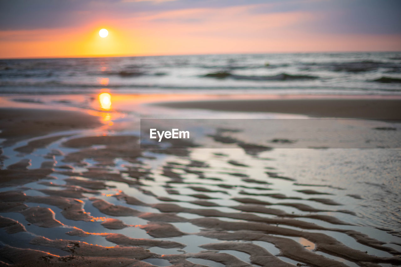 scenic view of sea at sunset