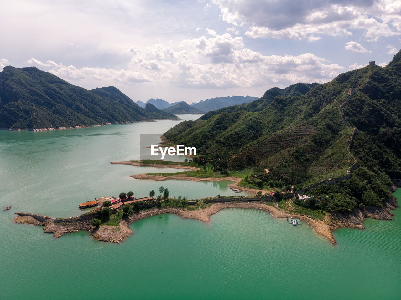 Scenic view of sea and mountains against sky