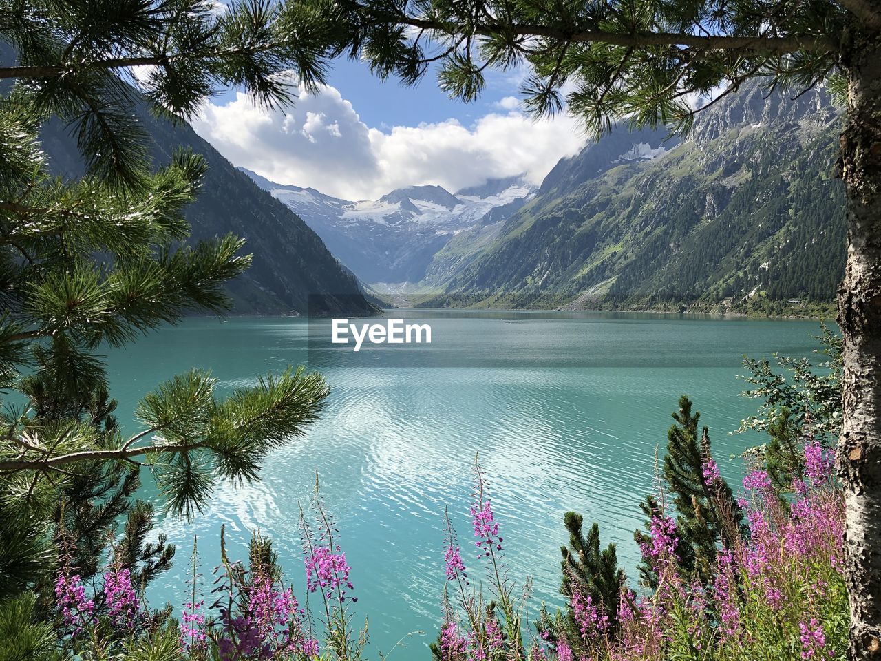 scenic view of lake and snowcapped mountains against sky