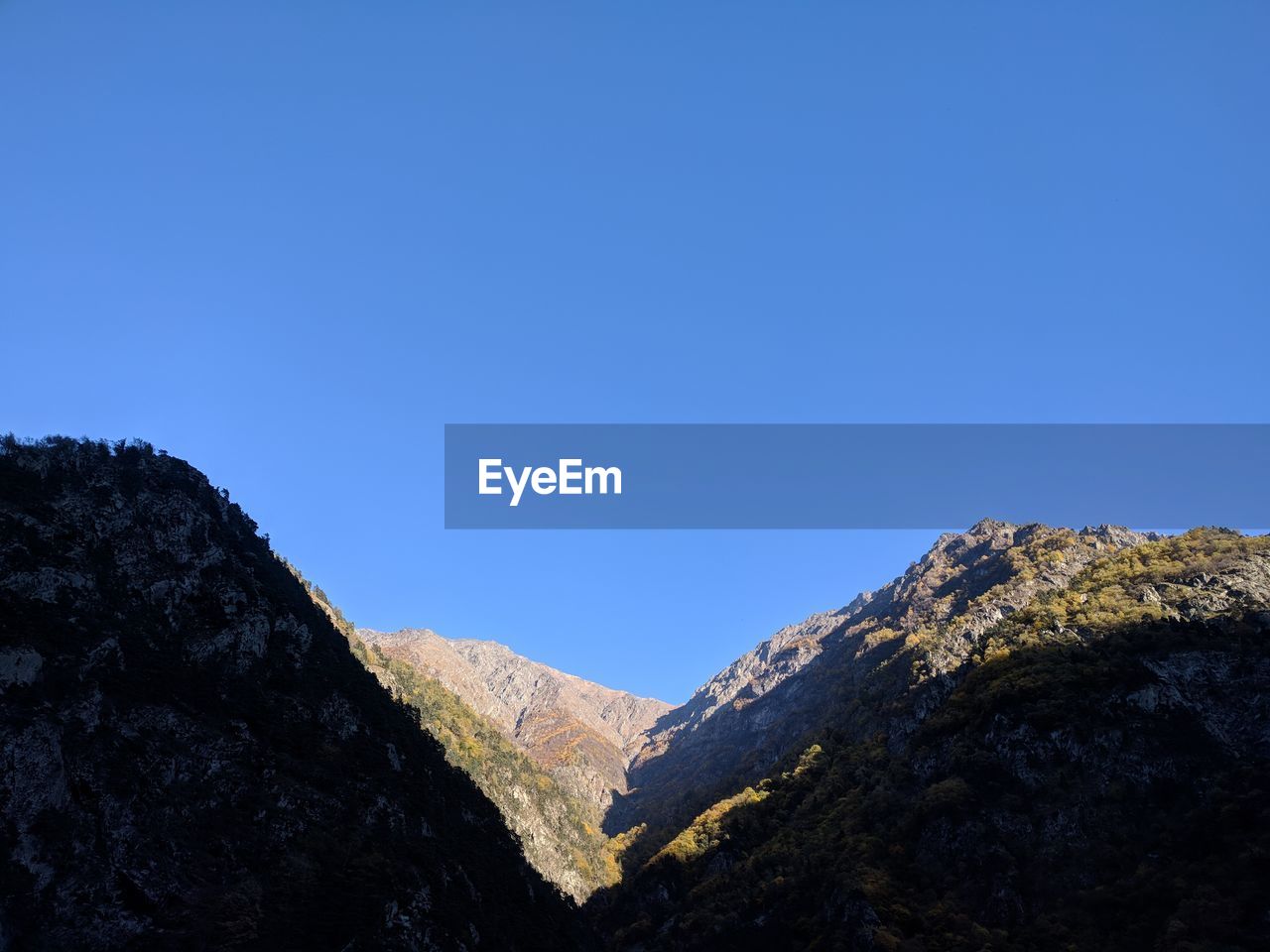 LOW ANGLE VIEW OF MOUNTAIN AGAINST BLUE SKY