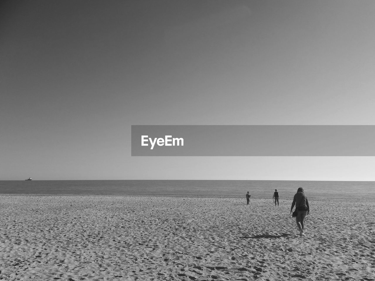 Scenic view of people on seaside against sky