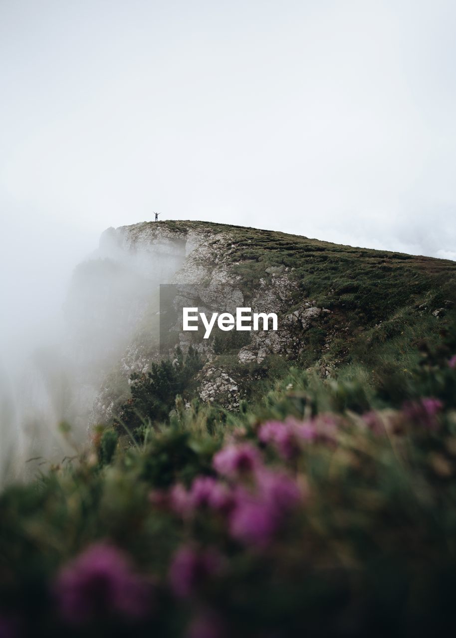 Low angle view of cliff against sky at bucegi natural park