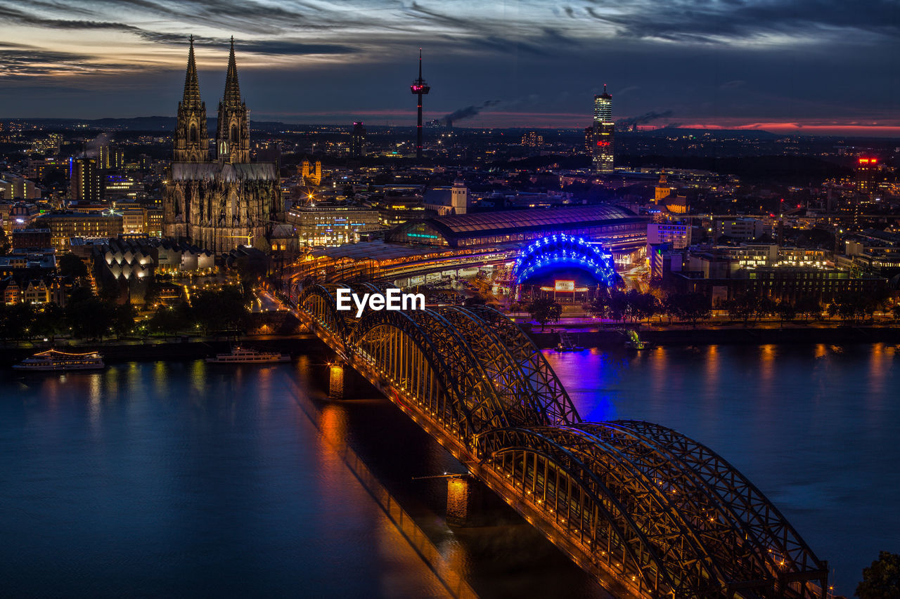 High angle view of hohenzollern bridge over rhine river against cologne cathedral