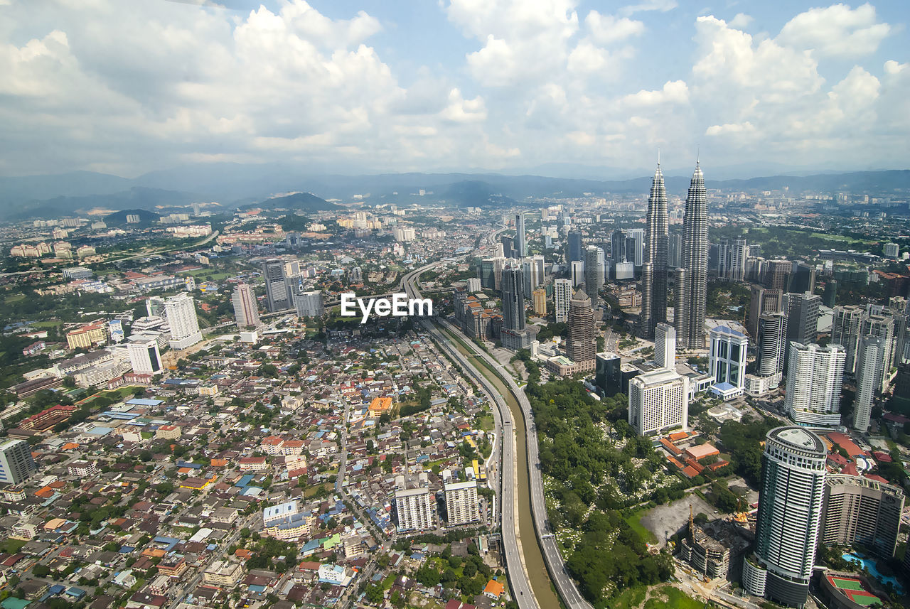 High angle view of modern buildings in city against sky