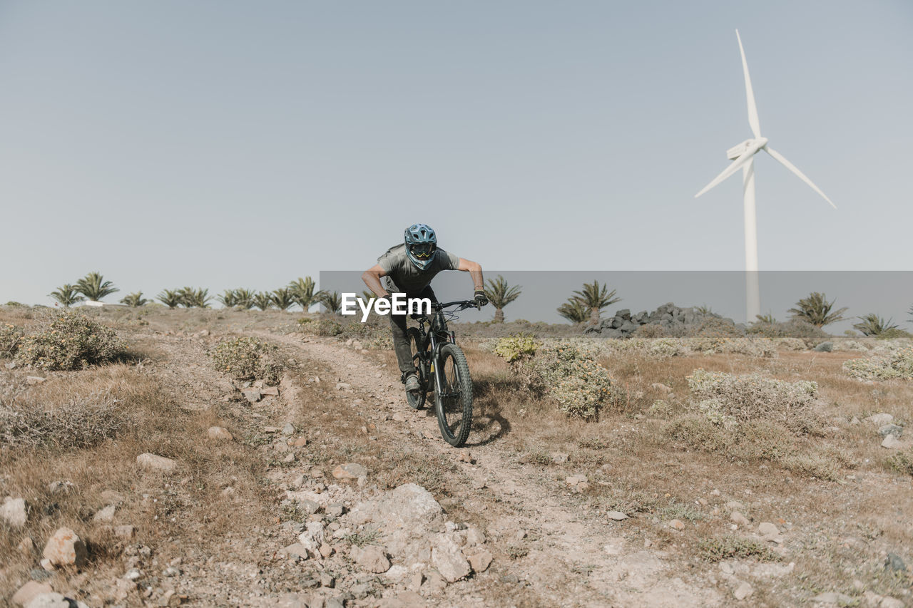 Spain, lanzarote, mountainbiker on a trip in desertic landscape