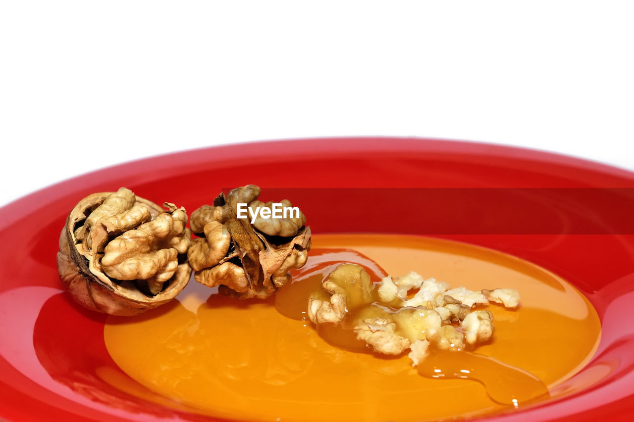 Close-up of walnuts with honey in plate