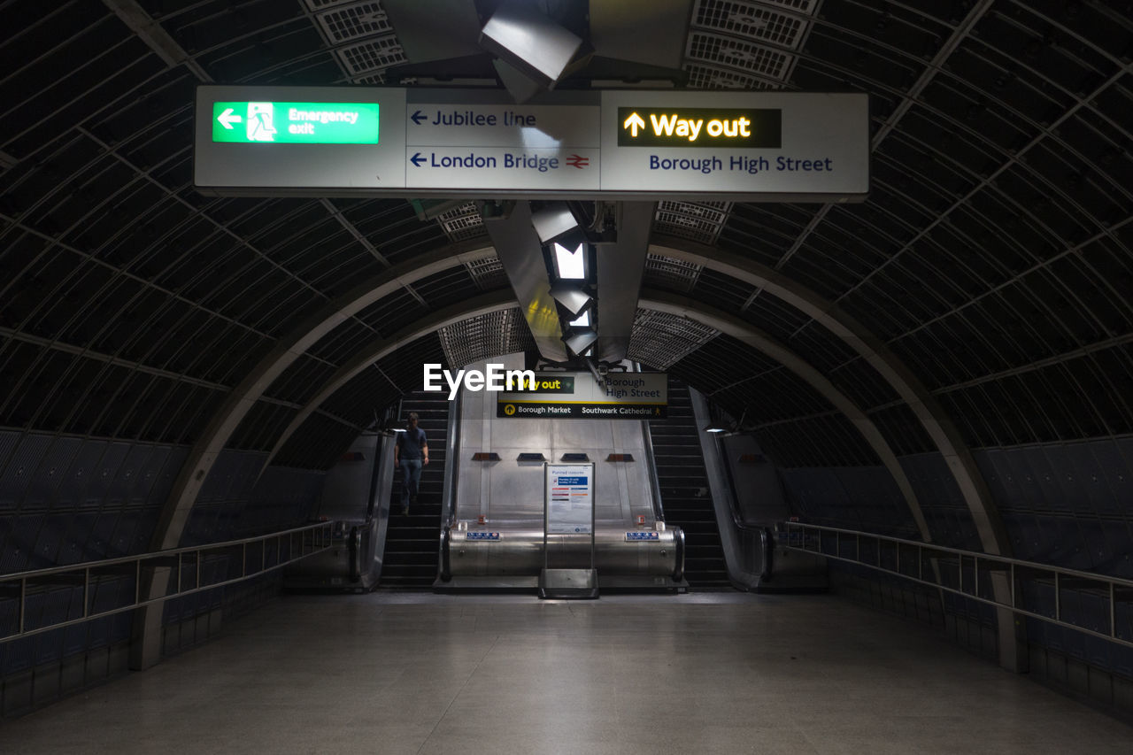 LOW ANGLE VIEW OF ILLUMINATED SIGN ON CEILING