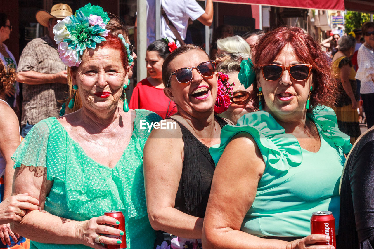 GROUP OF PEOPLE AT STREET MARKET IN TRADITIONAL CLOTHING