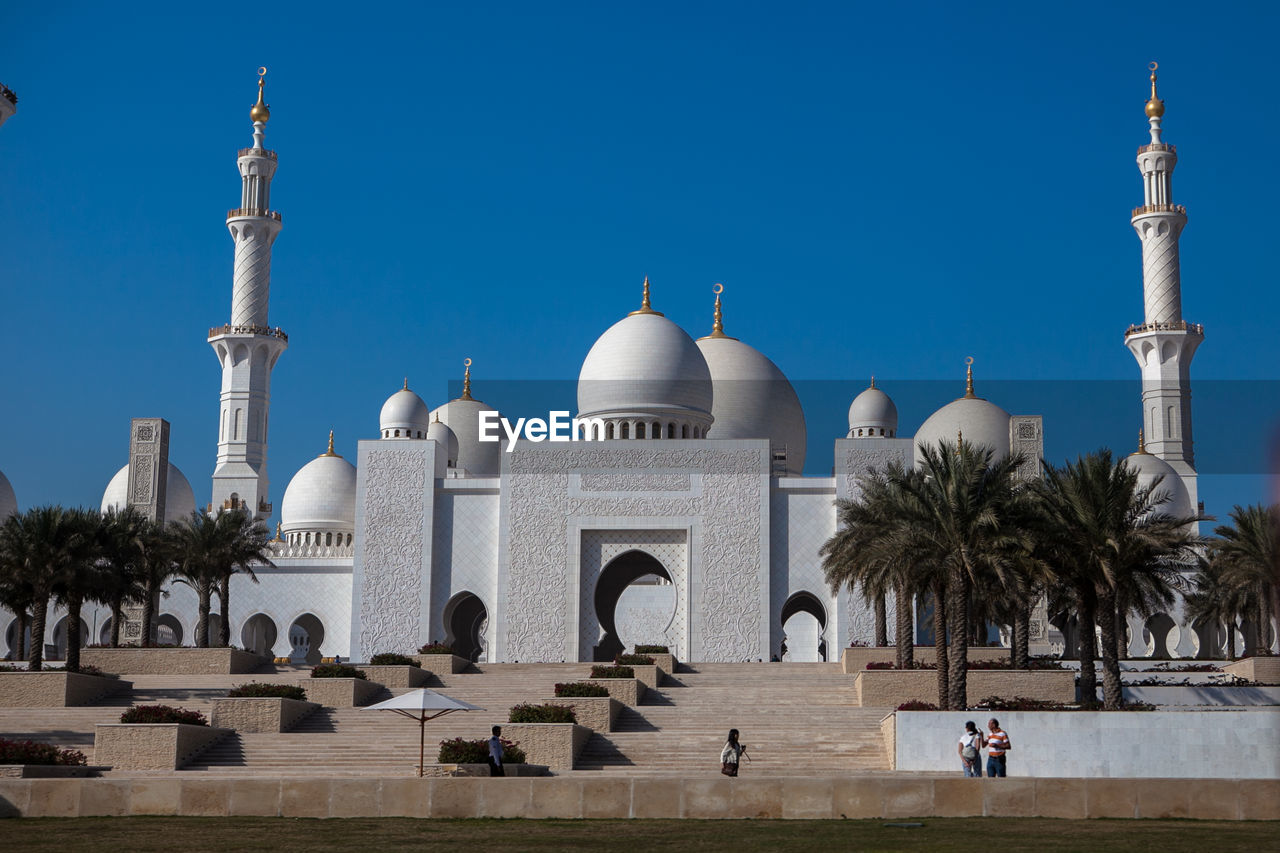 Low angle view of sheikh zayed mosque against clear blue sky