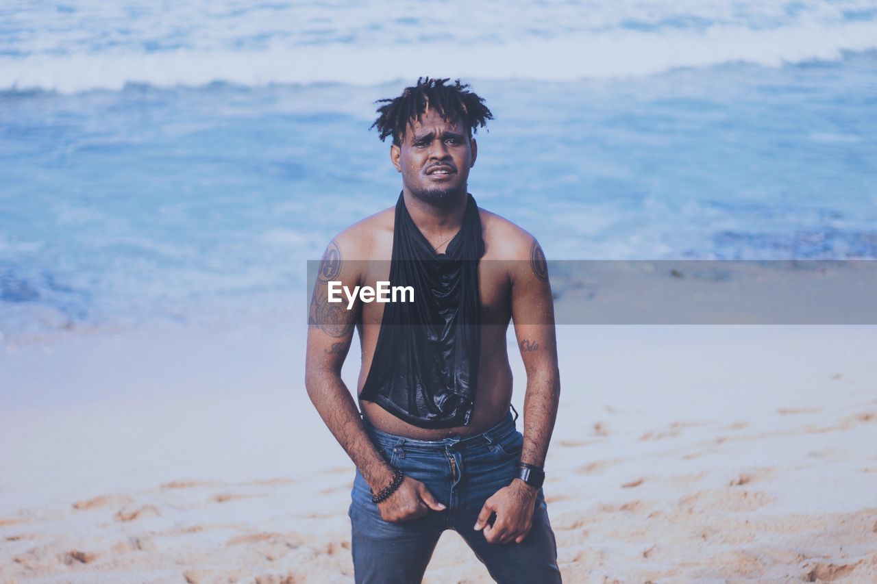 Young man standing on beach