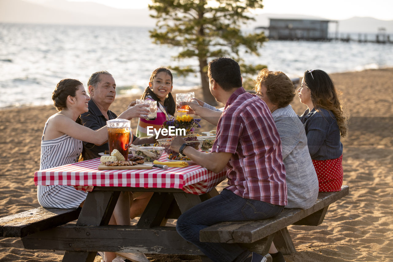 A family enjoys a beach bbq on the shoreline of lake tahoe, nv