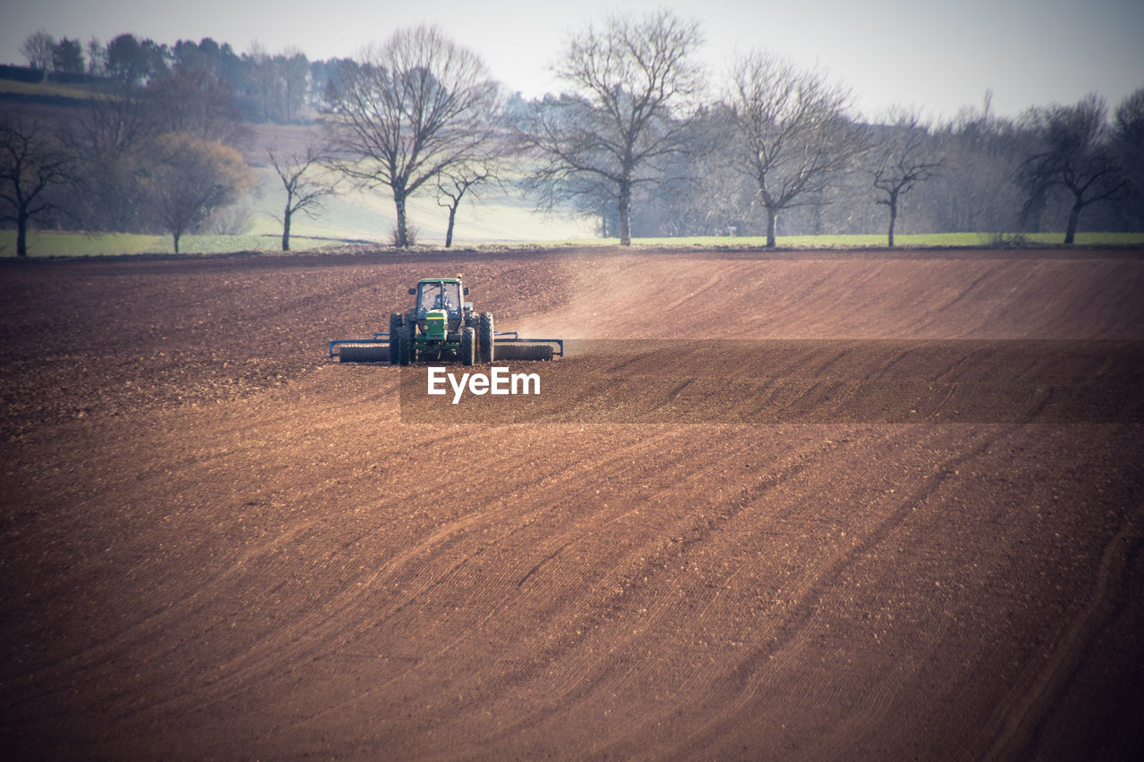 Scenic view of agricultural field with tractor