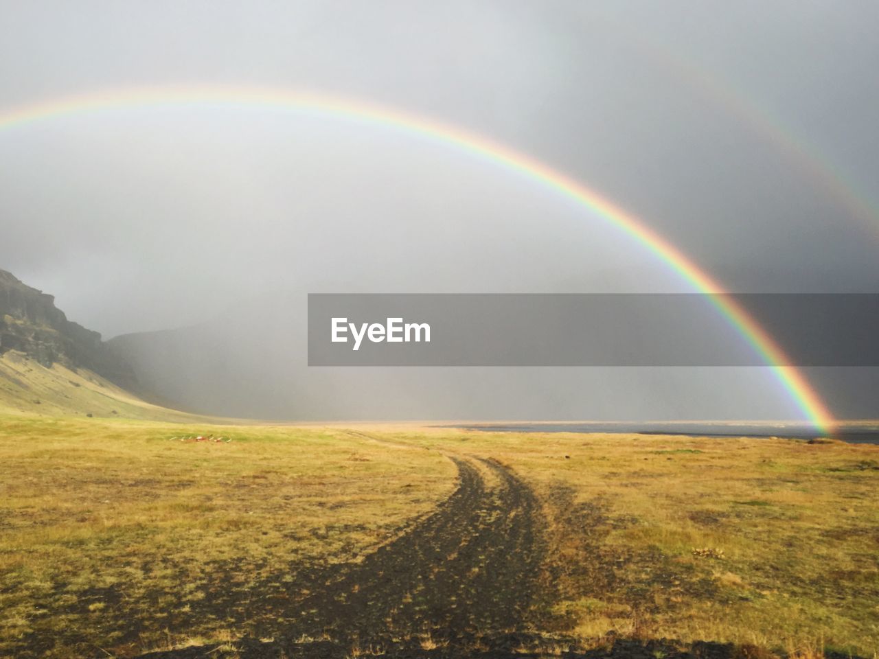 SCENIC VIEW OF RAINBOW OVER FIELD