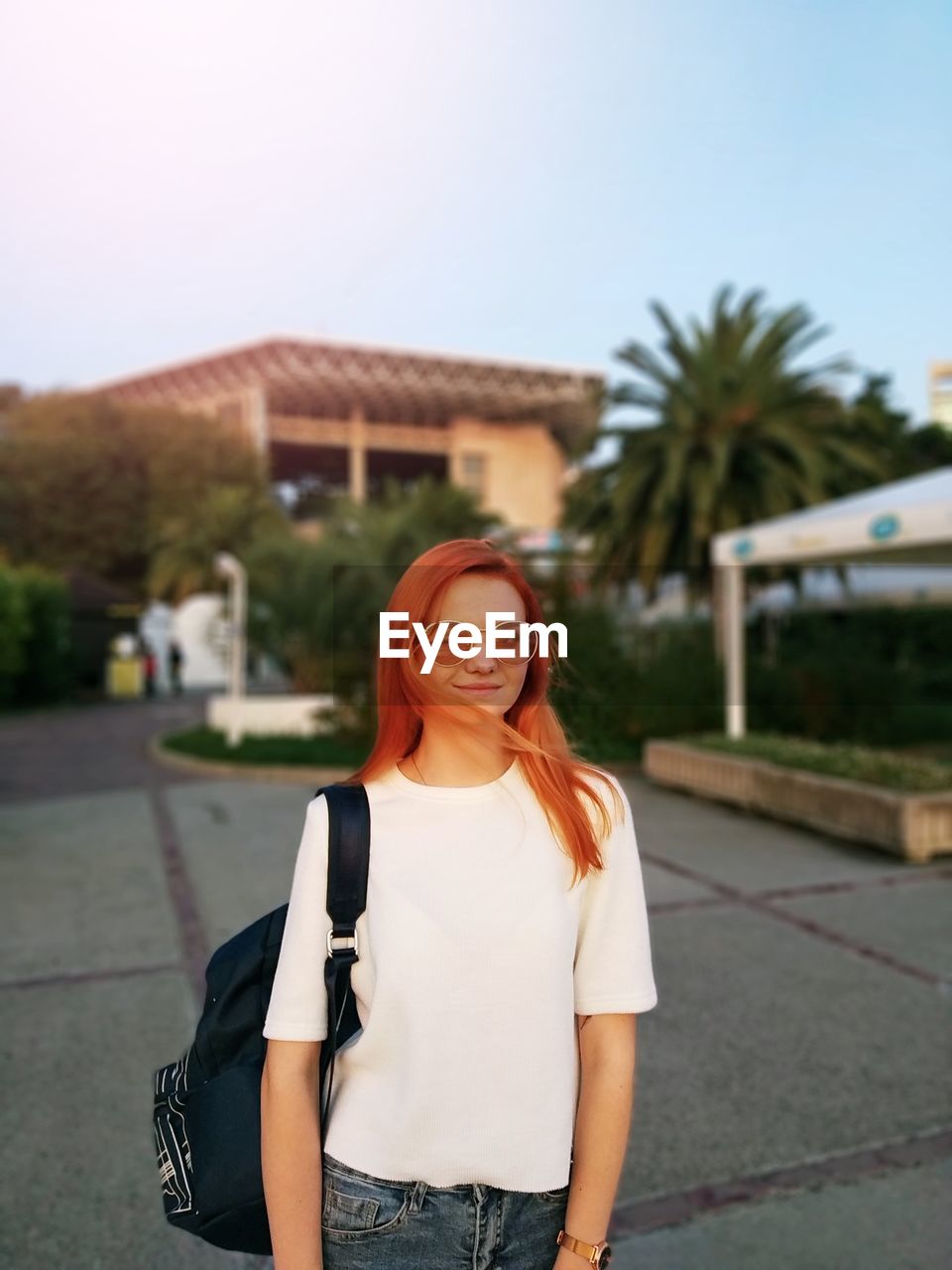 Portrait of young woman wearing sunglasses standing outdoors